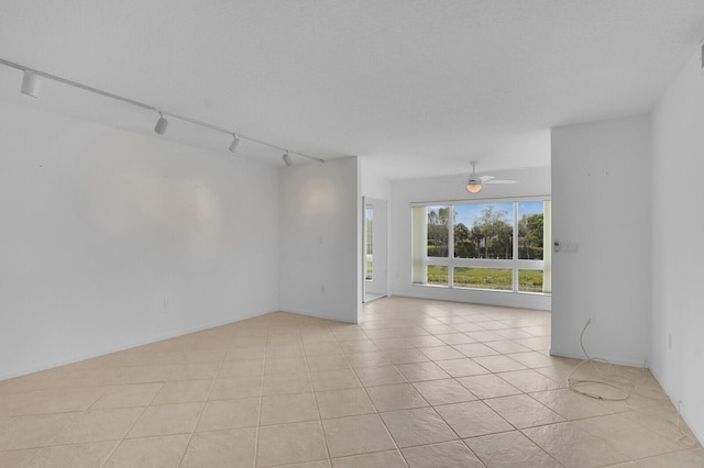 5874 Crystal Shores Dr Unit 308, Boynton Beach, FL 33437 - spare room with track lighting, ceiling fan, and light tile patterned floors