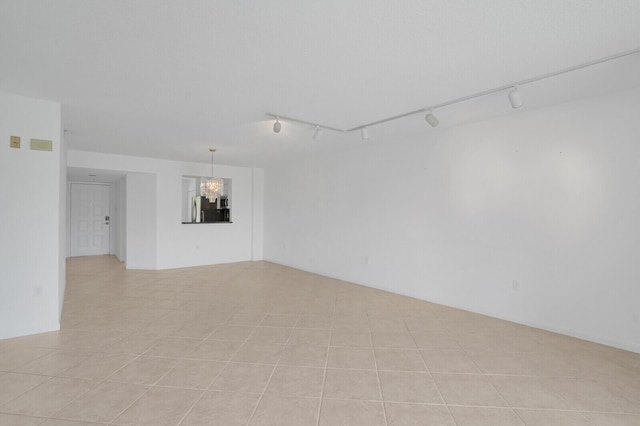 5874 Crystal Shores Dr Unit 308, Boynton Beach, FL 33437 - spare room featuring track lighting, a chandelier, and light tile patterned flooring