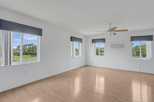 5874 Crystal Shores Dr Unit 308, Boynton Beach, FL 33437 - empty room with light wood finished floors, ceiling fan, and baseboards
