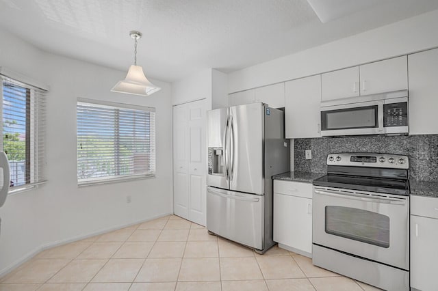 5874 Crystal Shores Dr Unit 308, Boynton Beach, FL 33437 - kitchen featuring appliances with stainless steel finishes, white cabinets, backsplash, pendant lighting, and dark stone counters