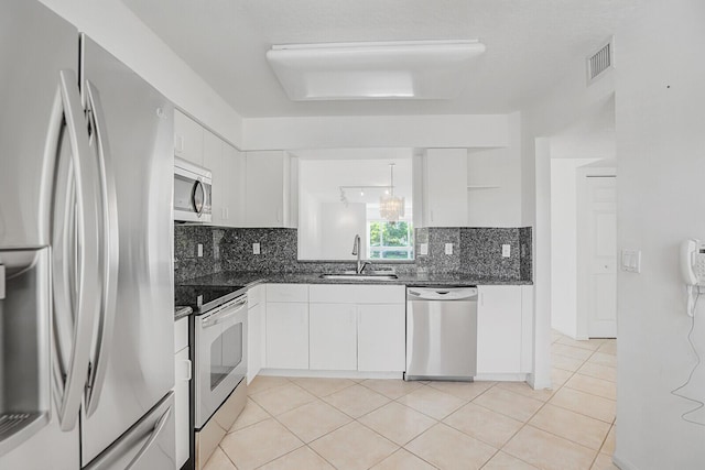 5874 Crystal Shores Dr Unit 308, Boynton Beach, FL 33437 - kitchen with stainless steel appliances, a sink, tasteful backsplash, white cabinets, and open shelves