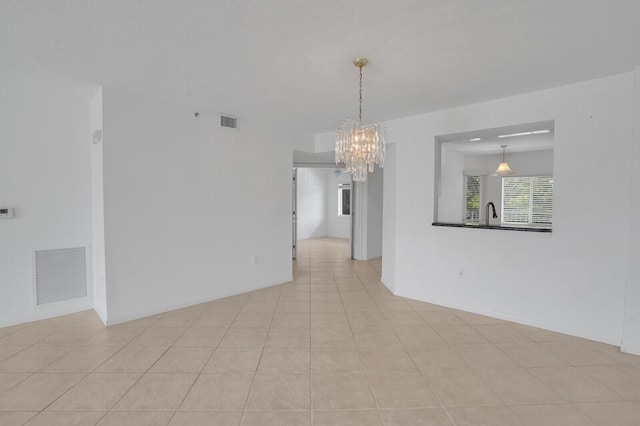 5874 Crystal Shores Dr Unit 308, Boynton Beach, FL 33437 - tiled spare room featuring a chandelier