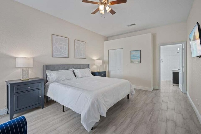 bedroom featuring baseboards, visible vents, a closet, and light wood-style flooring