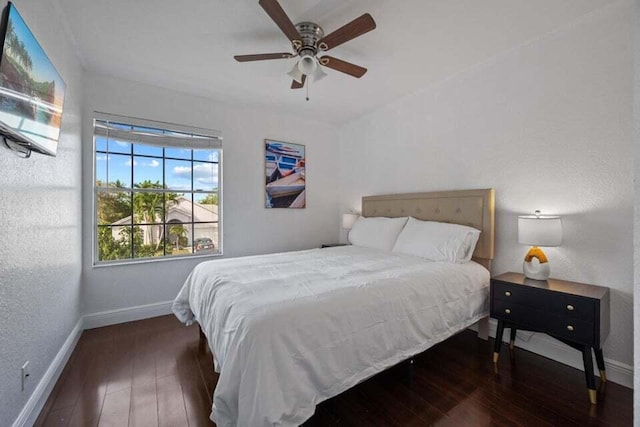 bedroom with baseboards, a ceiling fan, and wood-type flooring