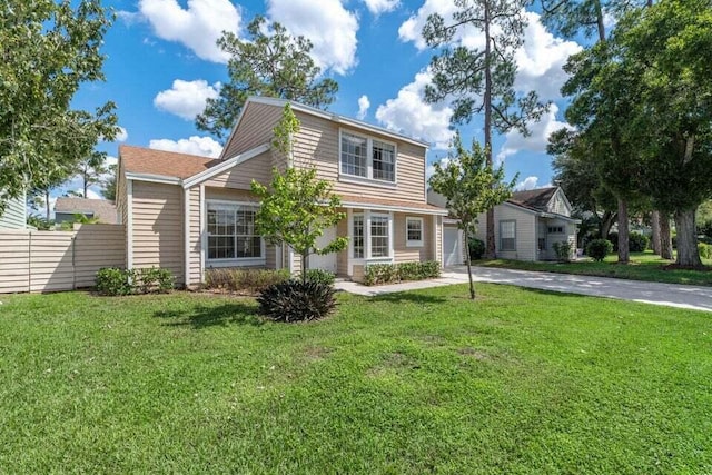 view of front of house featuring fence, concrete driveway, a front lawn, and a garage