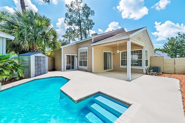 rear view of property with central AC, a patio area, an outbuilding, and a storage shed