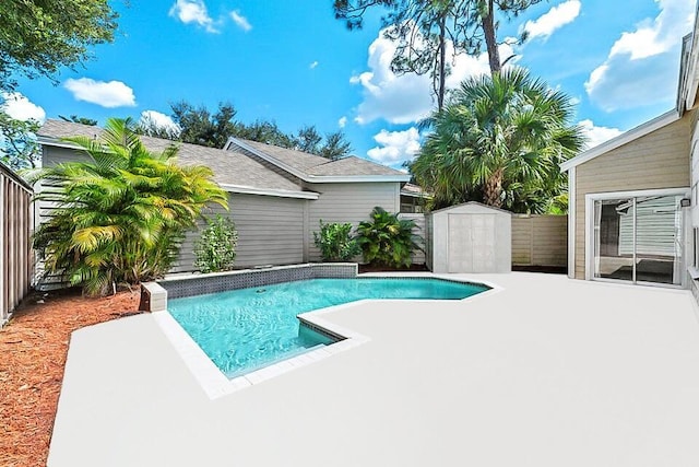 view of swimming pool with an outdoor structure, a patio, a fenced in pool, a storage unit, and a fenced backyard