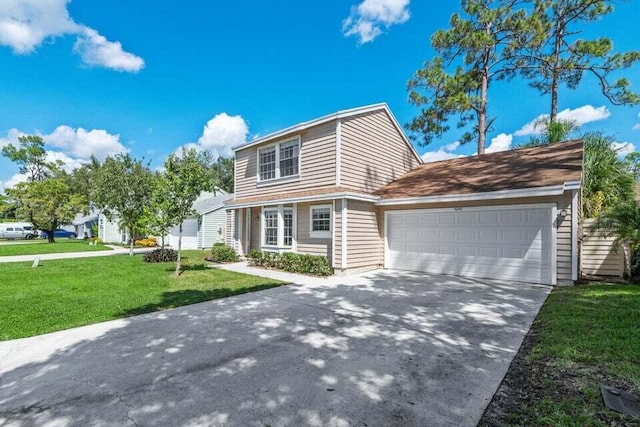 view of front of house featuring driveway, a front lawn, and an attached garage