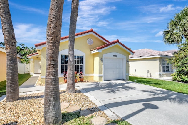 8024 Stirrup Cay Ct, Boynton Beach, FL 33436 - mediterranean / spanish-style home featuring a tiled roof, driveway, fence, an attached garage, and stucco siding