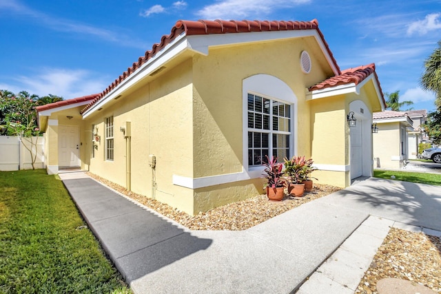 8024 Stirrup Cay Ct, Boynton Beach, FL 33436 - view of side of property with fence, stucco siding, and a tiled roof