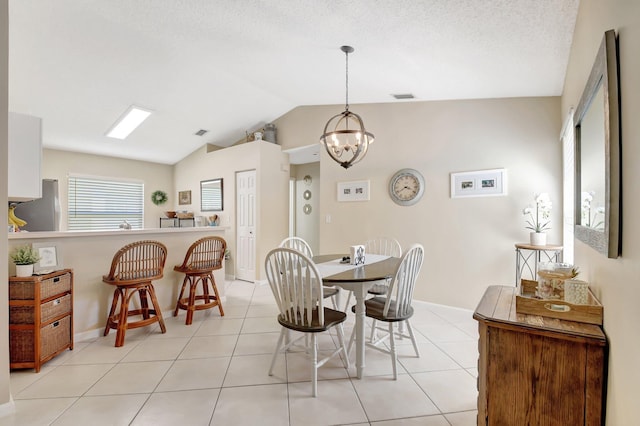 8024 Stirrup Cay Ct, Boynton Beach, FL 33436 - dining room with visible vents, a chandelier, baseboards, light tile patterned floors, and vaulted ceiling