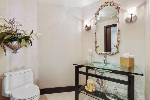300 SE 5th Ave Unit 2050, Boca Raton, FL 33432 - half bath with a sink, toilet, marble finish floor, baseboards, and wallpapered walls