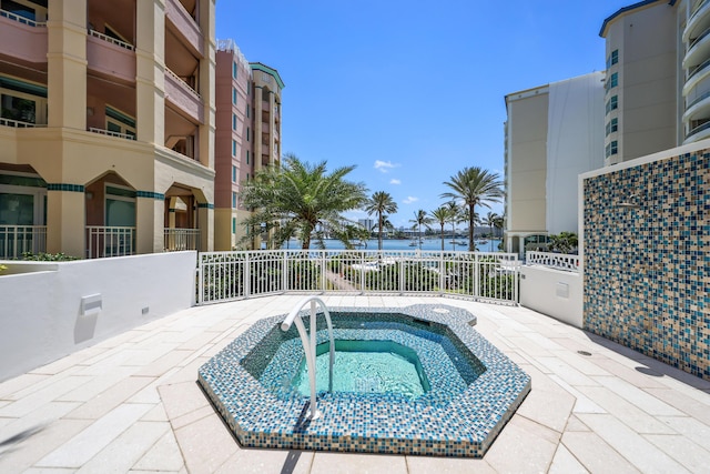 300 SE 5th Ave Unit 2050, Boca Raton, FL 33432 - view of pool featuring fence, a water view, and a community hot tub