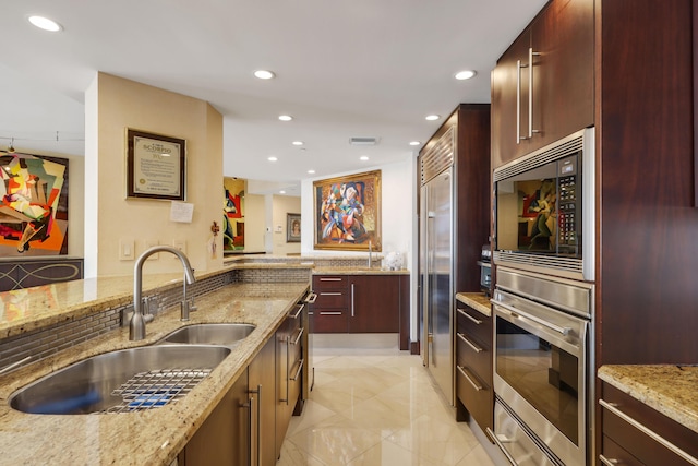 300 SE 5th Ave Unit 2050, Boca Raton, FL 33432 - kitchen featuring a sink, built in appliances, modern cabinets, and recessed lighting