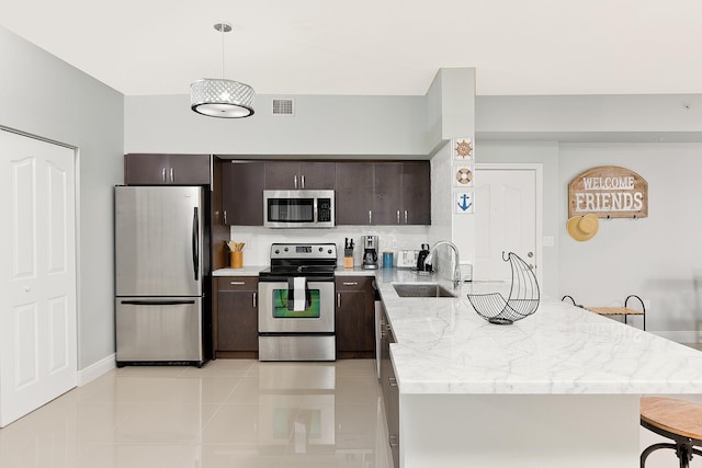 255 NE 3rd Ave Unit 2501, Delray Beach, FL 33444 - kitchen with a sink, visible vents, stainless steel appliances, dark brown cabinets, and a peninsula