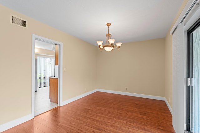 6534 Spring Bottom Way Unit 123, Boca Raton, FL 33433 - unfurnished room with visible vents, light wood finished floors, baseboards, and an inviting chandelier