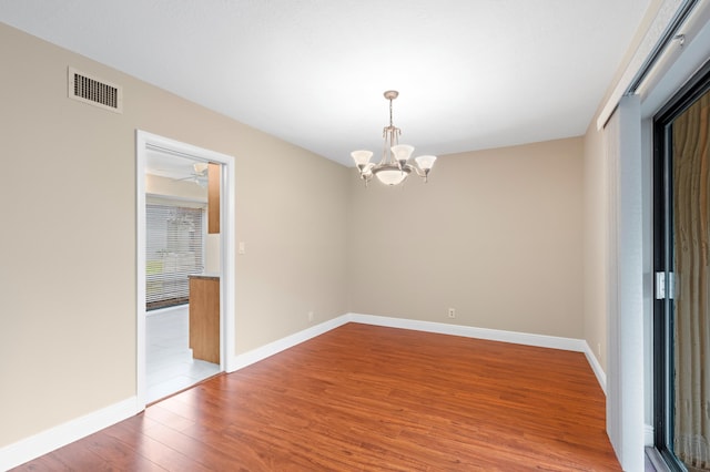 6534 Spring Bottom Way Unit 123, Boca Raton, FL 33433 - spare room featuring baseboards, a notable chandelier, wood finished floors, and visible vents