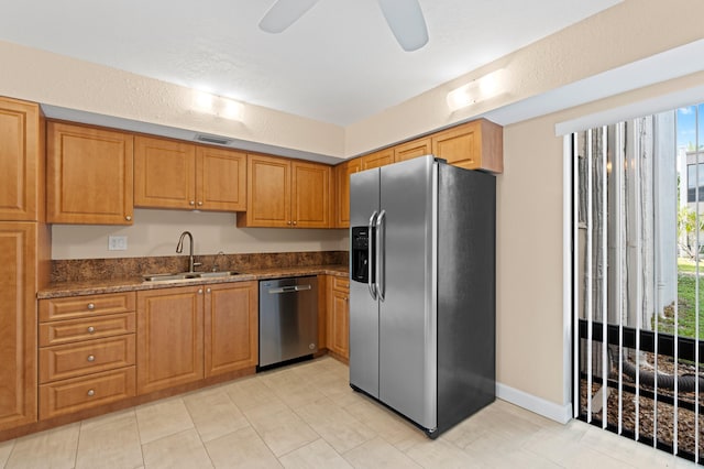 6534 Spring Bottom Way Unit 123, Boca Raton, FL 33433 - kitchen featuring appliances with stainless steel finishes, a sink, brown cabinetry, dark stone countertops, and visible vents