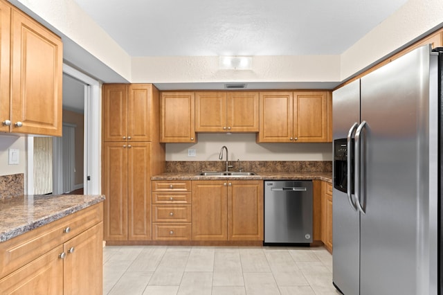 6534 Spring Bottom Way Unit 123, Boca Raton, FL 33433 - kitchen featuring visible vents, brown cabinets, a sink, light tile patterned floors, and stainless steel appliances