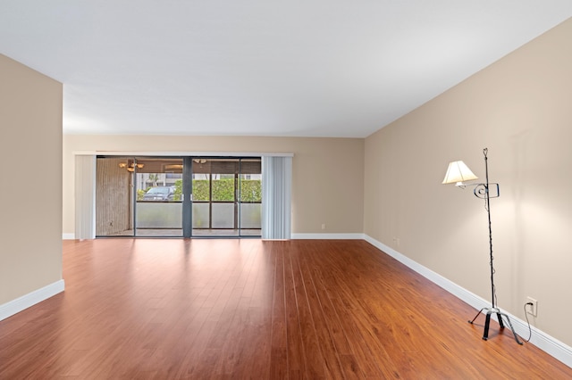 6534 Spring Bottom Way Unit 123, Boca Raton, FL 33433 - unfurnished living room featuring baseboards, a notable chandelier, and wood finished floors