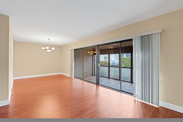 6534 Spring Bottom Way Unit 123, Boca Raton, FL 33433 - spare room featuring baseboards, a chandelier, and wood finished floors
