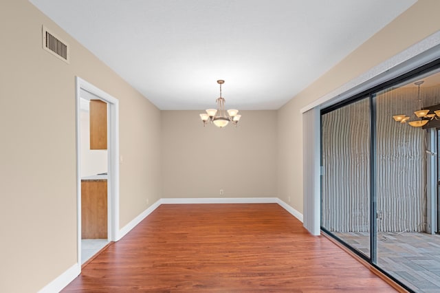 6534 Spring Bottom Way Unit 123, Boca Raton, FL 33433 - spare room with an inviting chandelier, baseboards, wood finished floors, and visible vents