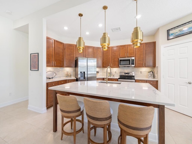 6000 Venetto Way, Vero Beach, FL 32967 - kitchen featuring appliances with stainless steel finishes, brown cabinets, backsplash, and a sink