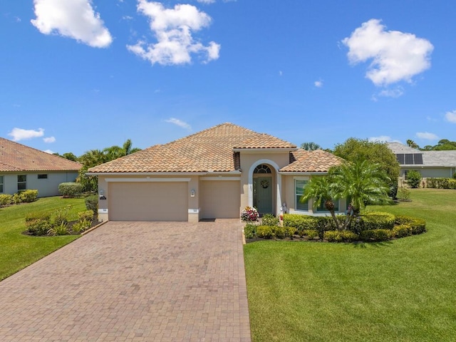 6000 Venetto Way, Vero Beach, FL 32967 - mediterranean / spanish home featuring an attached garage, a tile roof, decorative driveway, and stucco siding