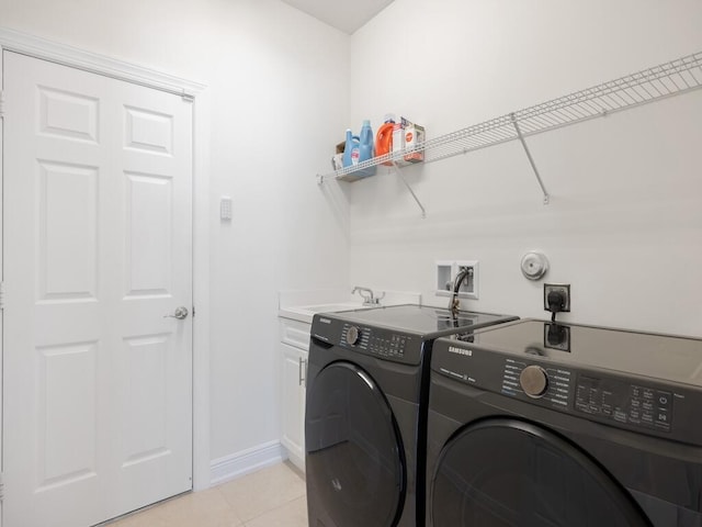 6000 Venetto Way, Vero Beach, FL 32967 - laundry area featuring a sink, cabinet space, washing machine and clothes dryer, light tile patterned floors, and baseboards