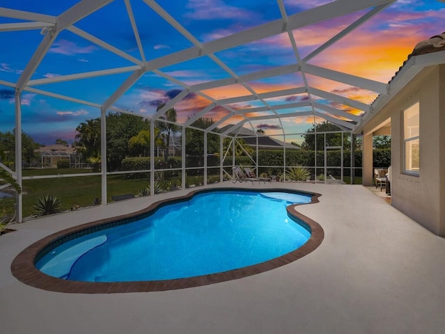 6000 Venetto Way, Vero Beach, FL 32967 - pool at dusk featuring a lanai, an outdoor pool, and a patio