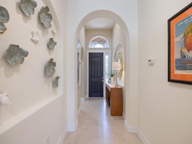 6000 Venetto Way, Vero Beach, FL 32967 - foyer entrance with light tile patterned floors, arched walkways, and baseboards