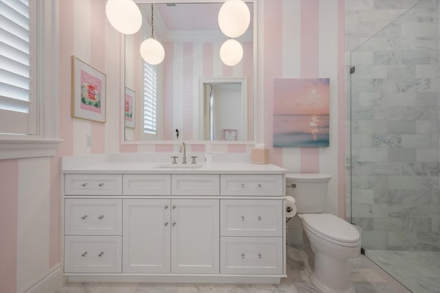 bathroom featuring vanity, toilet, tiled shower, and wallpapered walls