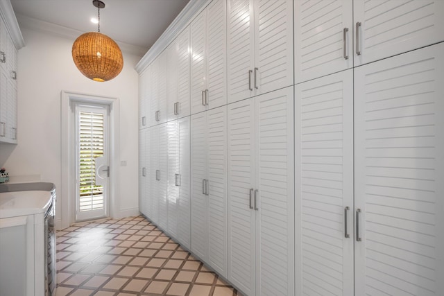 clothes washing area featuring baseboards, independent washer and dryer, and cabinet space