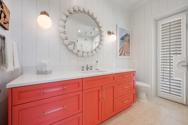 bathroom with vanity, ornamental molding, and toilet