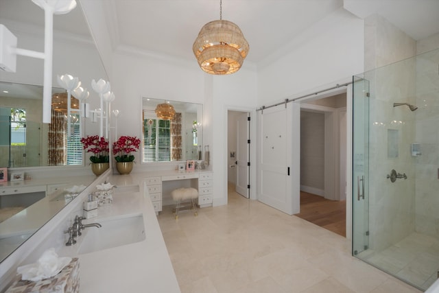 full bathroom with a notable chandelier, a sink, double vanity, ornamental molding, and a stall shower
