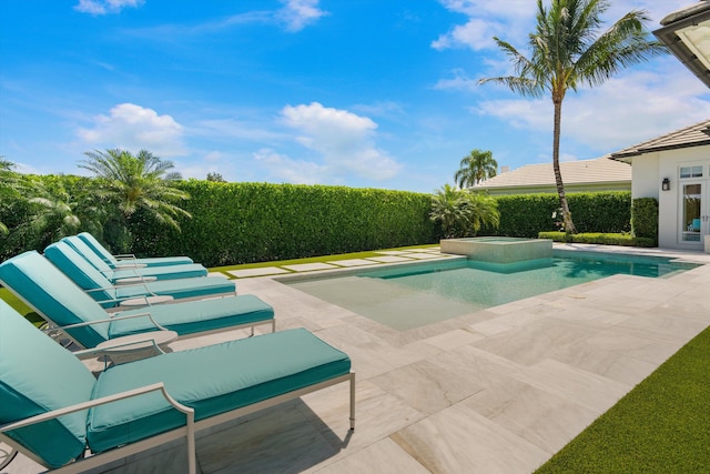 view of swimming pool with a pool with connected hot tub and a patio area