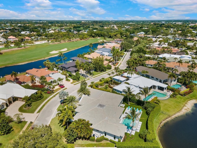 bird's eye view with a water view, view of golf course, and a residential view