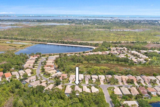 drone / aerial view featuring a residential view and a water view