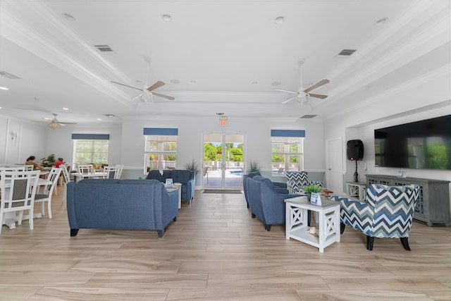 living room with visible vents, ornamental molding, ceiling fan, and plenty of natural light