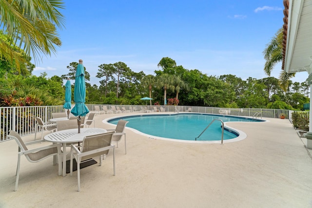 pool with fence and a patio area
