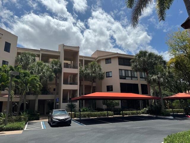 7546 La Paz Blvd Unit 408, Boca Raton, FL 33433 - view of apartment building / complex featuring uncovered parking