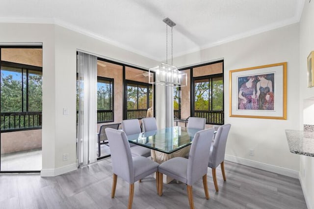 7546 La Paz Blvd Unit 408, Boca Raton, FL 33433 - dining area featuring wood finished floors, crown molding, baseboards, and a chandelier