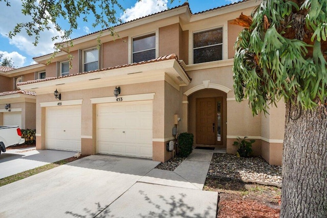 453 Rainbow Springs Ter, Royal Palm Beach, FL 33411 - multi unit property with concrete driveway, stucco siding, a tile roof, and an attached garage