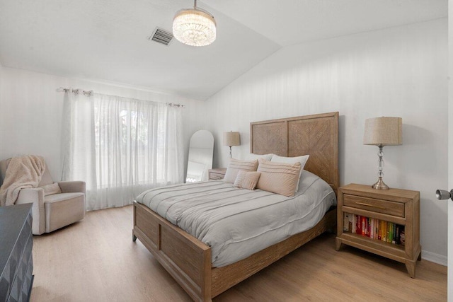 453 Rainbow Springs Ter, Royal Palm Beach, FL 33411 - bedroom featuring vaulted ceiling, wood finished floors, and a chandelier