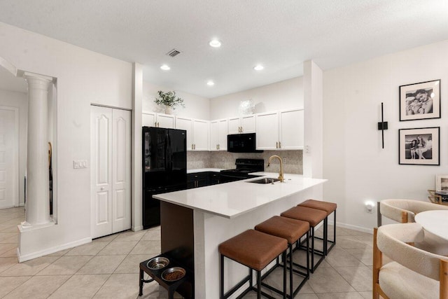 453 Rainbow Springs Ter, Royal Palm Beach, FL 33411 - kitchen with black appliances, ornate columns, a sink, light tile patterned flooring, and recessed lighting