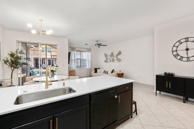 453 Rainbow Springs Ter, Royal Palm Beach, FL 33411 - kitchen featuring dishwasher, a sink, open floor plan, and light countertops