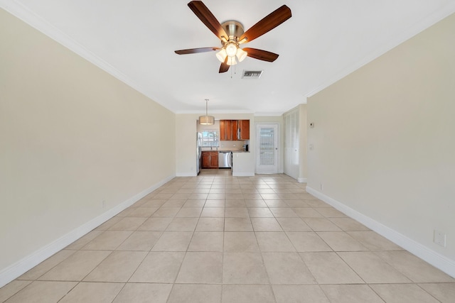 unfurnished living room featuring crown molding, a ceiling fan, baseboards, light tile patterned floors, and visible vents