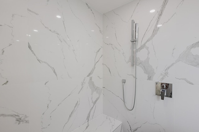 full bathroom featuring a marble finish shower