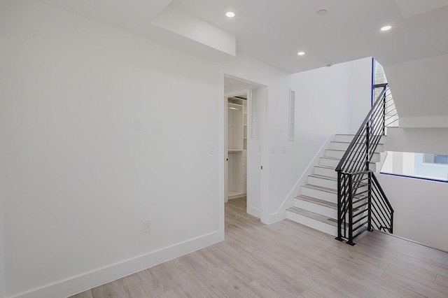 interior space featuring baseboards, recessed lighting, and wood finished floors