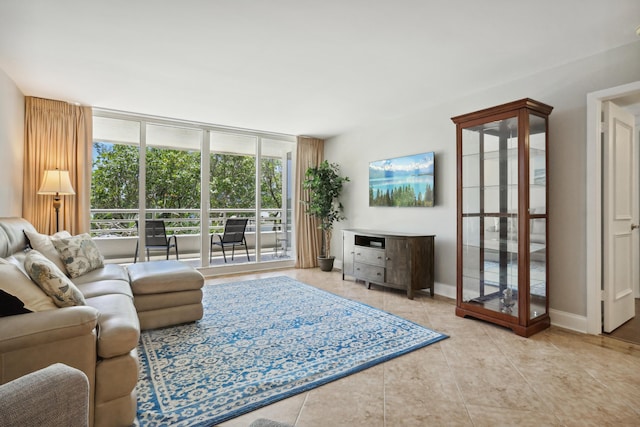 4201 N Ocean Blvd Unit 208, Boca Raton, FL 33431 - tiled living room with baseboards and floor to ceiling windows